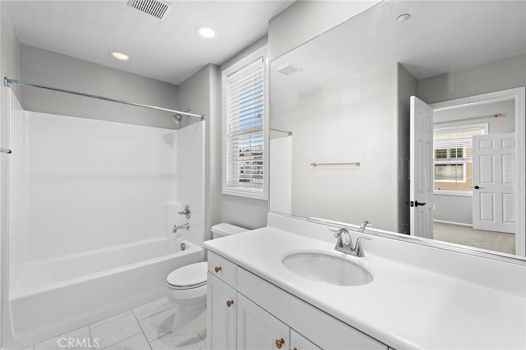 41 Passaflora Lane Ladera Ranch, CA 92694 - Photo 14 of 36 a bathroom with a granite countertop sink a toilet and shower