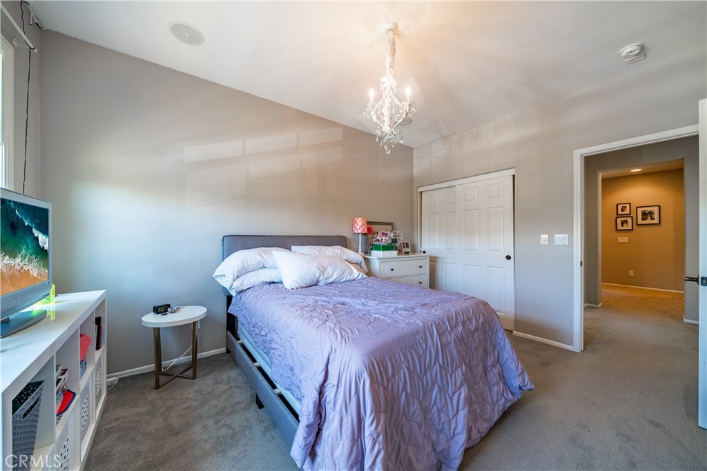 41 Passaflora Lane Ladera Ranch, CA 92694 - Photo 7 of 36 a bedroom with a bed and a chandelier