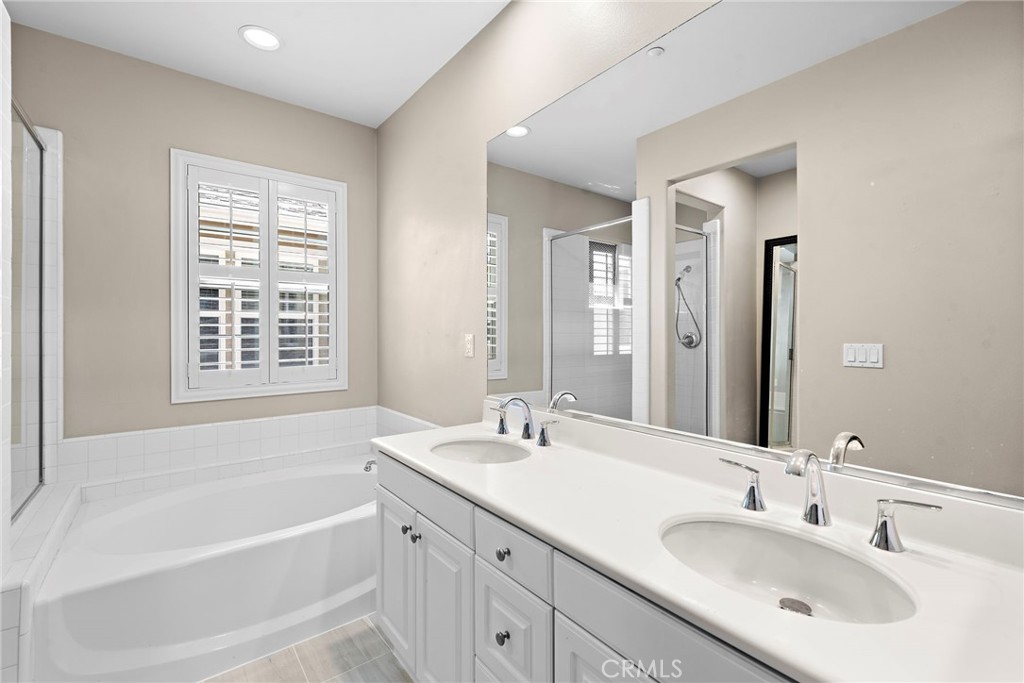 41 Passaflora Lane Ladera Ranch, CA 92694 - Photo 10 of 36 a bathroom with a tub sink and mirror