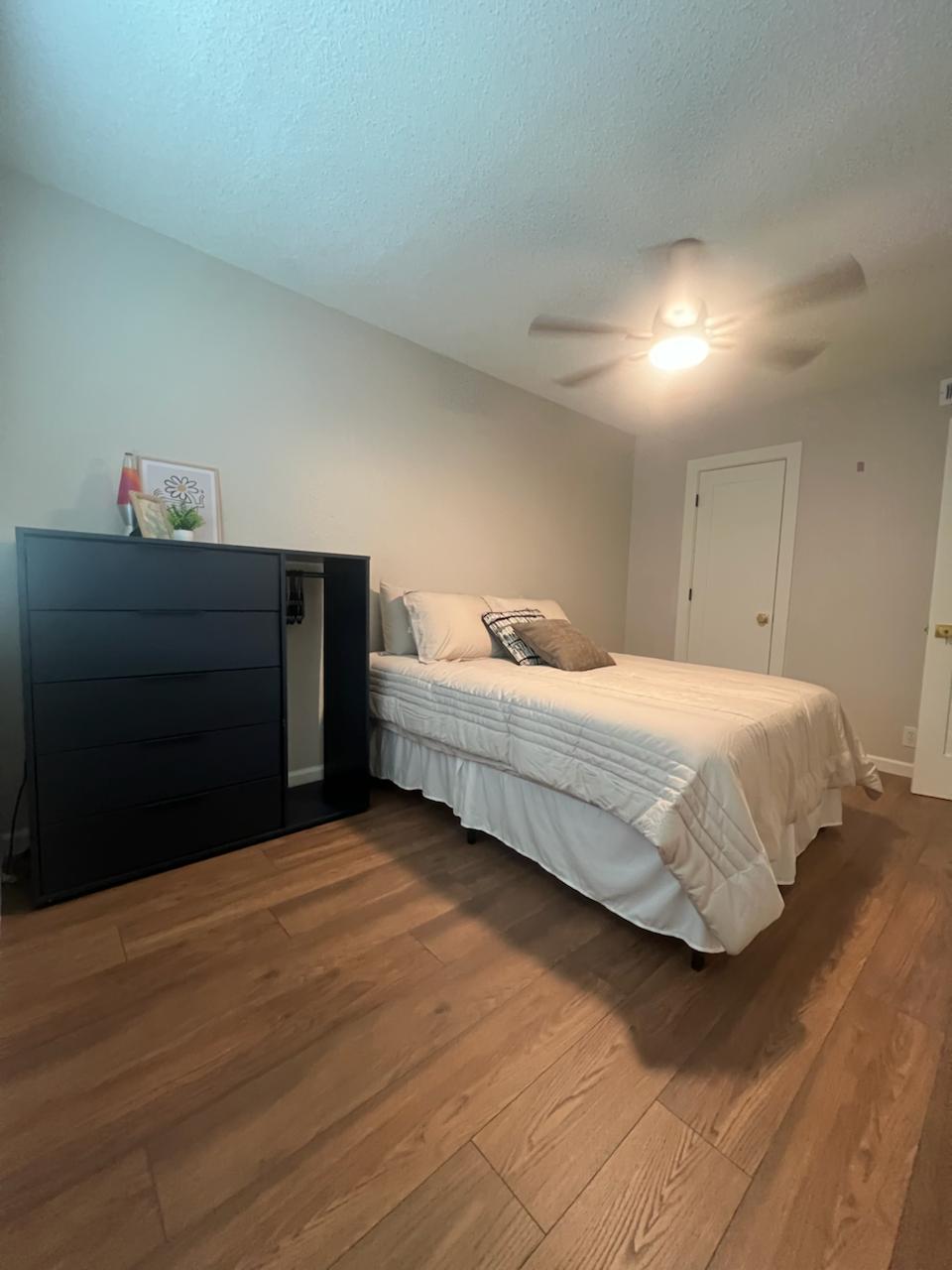 2401 Manor St Road, Unit 118 Austin, TX 78722 - Photo 13 of 17 a bedroom with a bed and a dresser