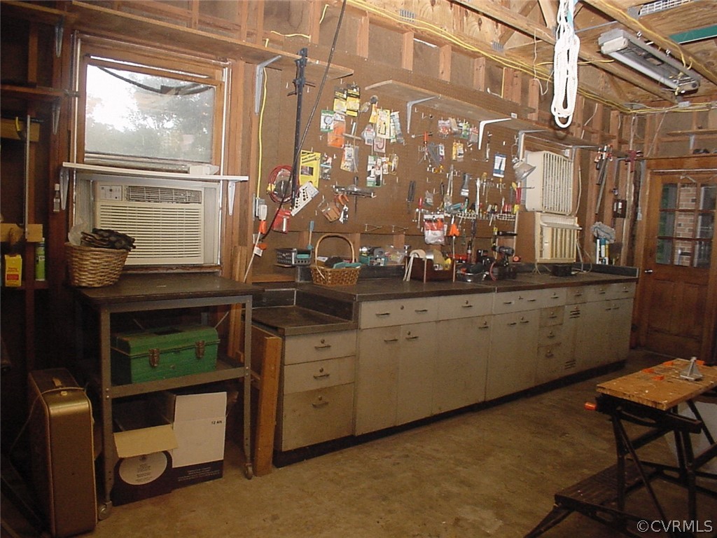 8420 Larkspur Road North Chesterfield, VA 23235 - Photo 40 of 47 Garage has cabinets w countertops, pegboard & pede