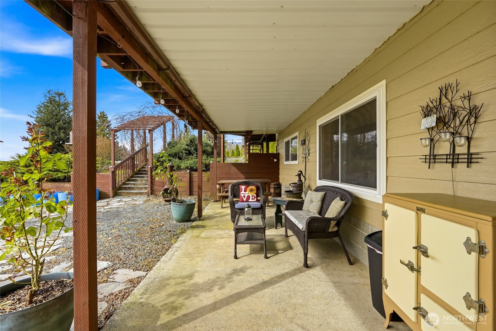 5334 Tenneson Road Sedro-Woolley, WA 98284 - Photo 26 of 39 a view of a patio with table and chairs potted plants with wooden floor and seating space