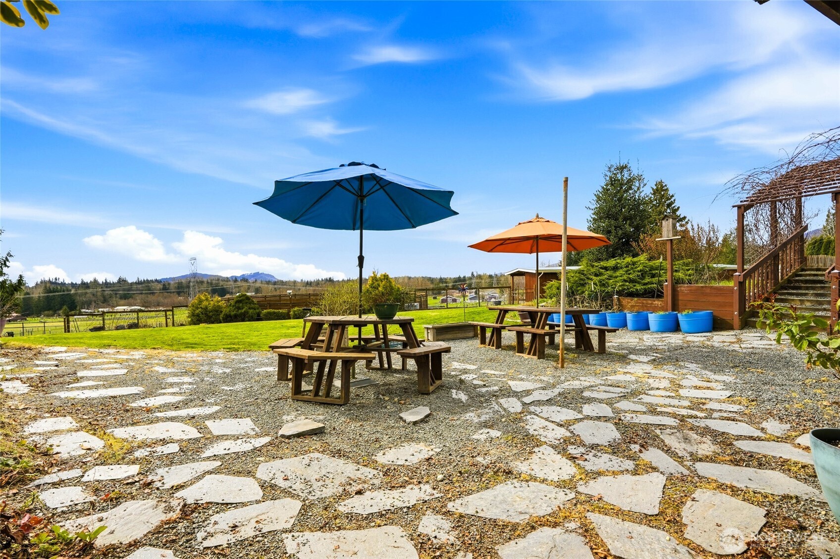 5334 Tenneson Road Sedro-Woolley, WA 98284 - Photo 27 of 39 a view of a swimming pool with a table and chairs under an umbrella