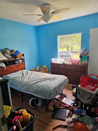 a bedroom with furniture and a chair