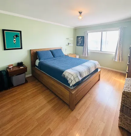 a bedroom with a large bed a chandelier and closet