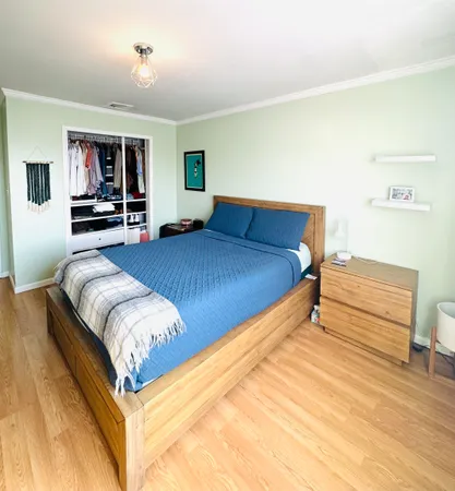 a bedroom with a bed and a mirror