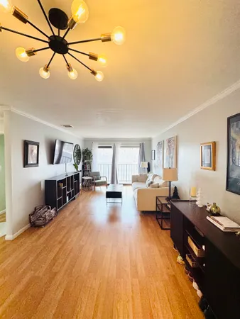 a living room with furniture and a dining table