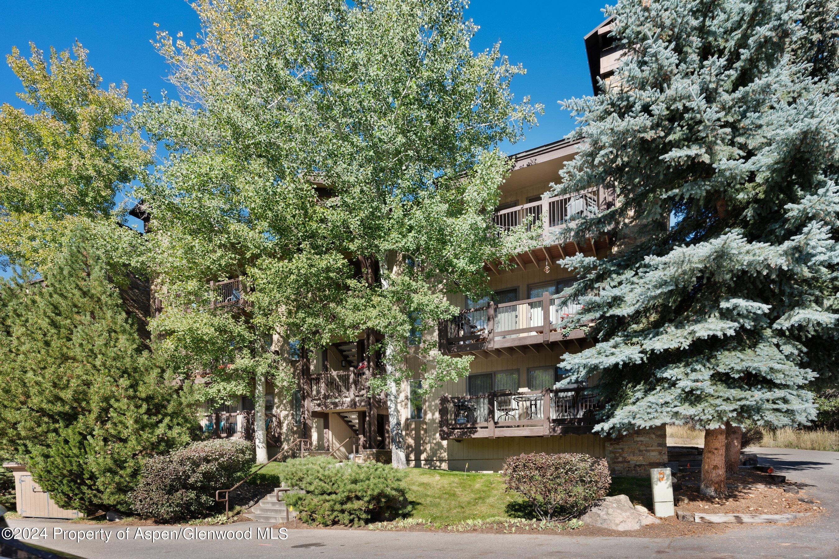 35 Upper Woodbridge Road, Unit 26EF Snowmass Village, CO 81615 - Photo 1 of 17 a view of a building with a garden