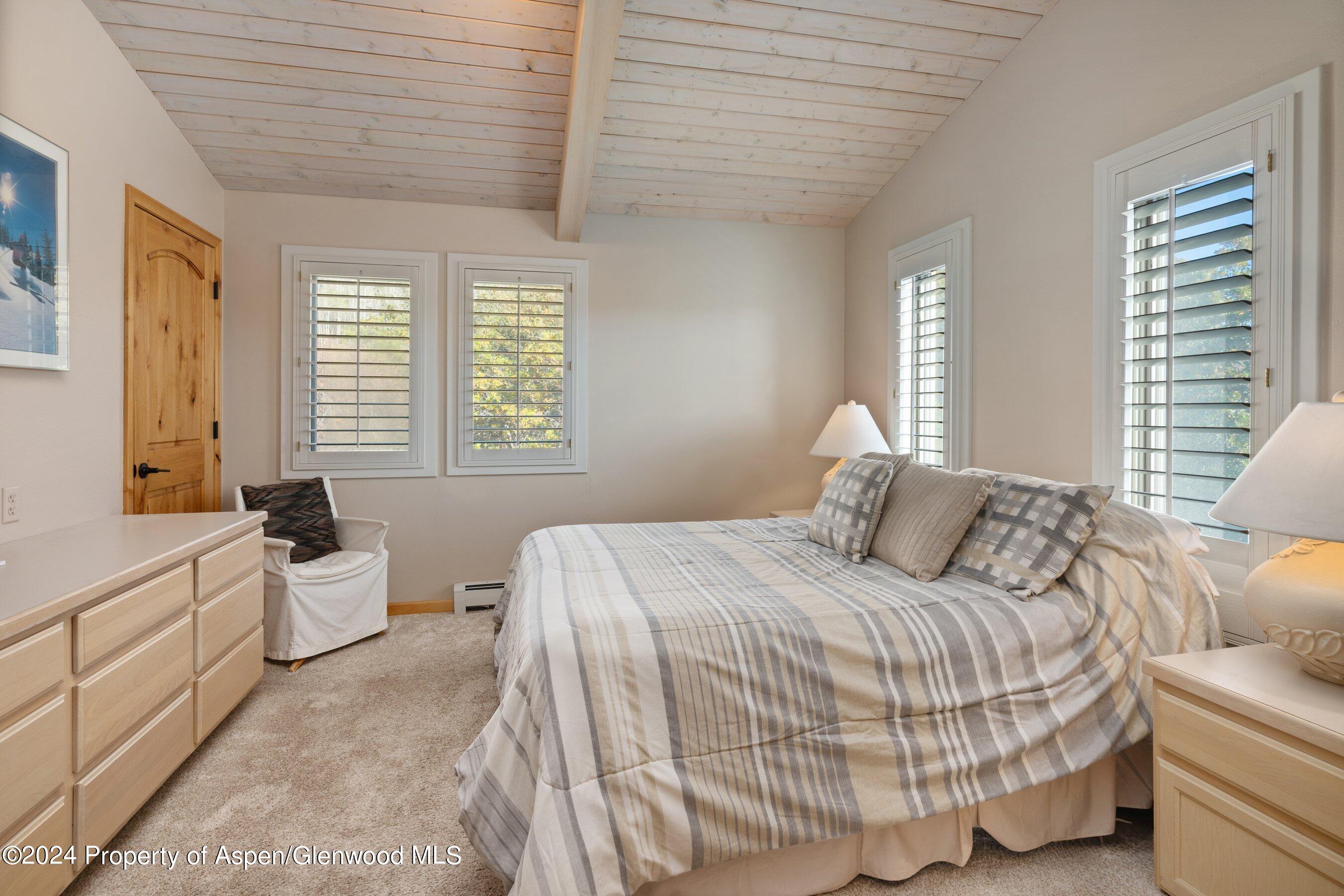 35 Upper Woodbridge Road, Unit 26EF Snowmass Village, CO 81615 - Photo 12 of 17 a bedroom with a bed and large windows
