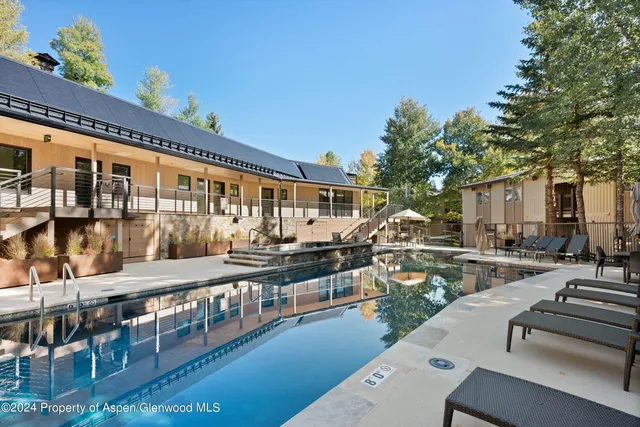 a view of a chairs and table in the balcony