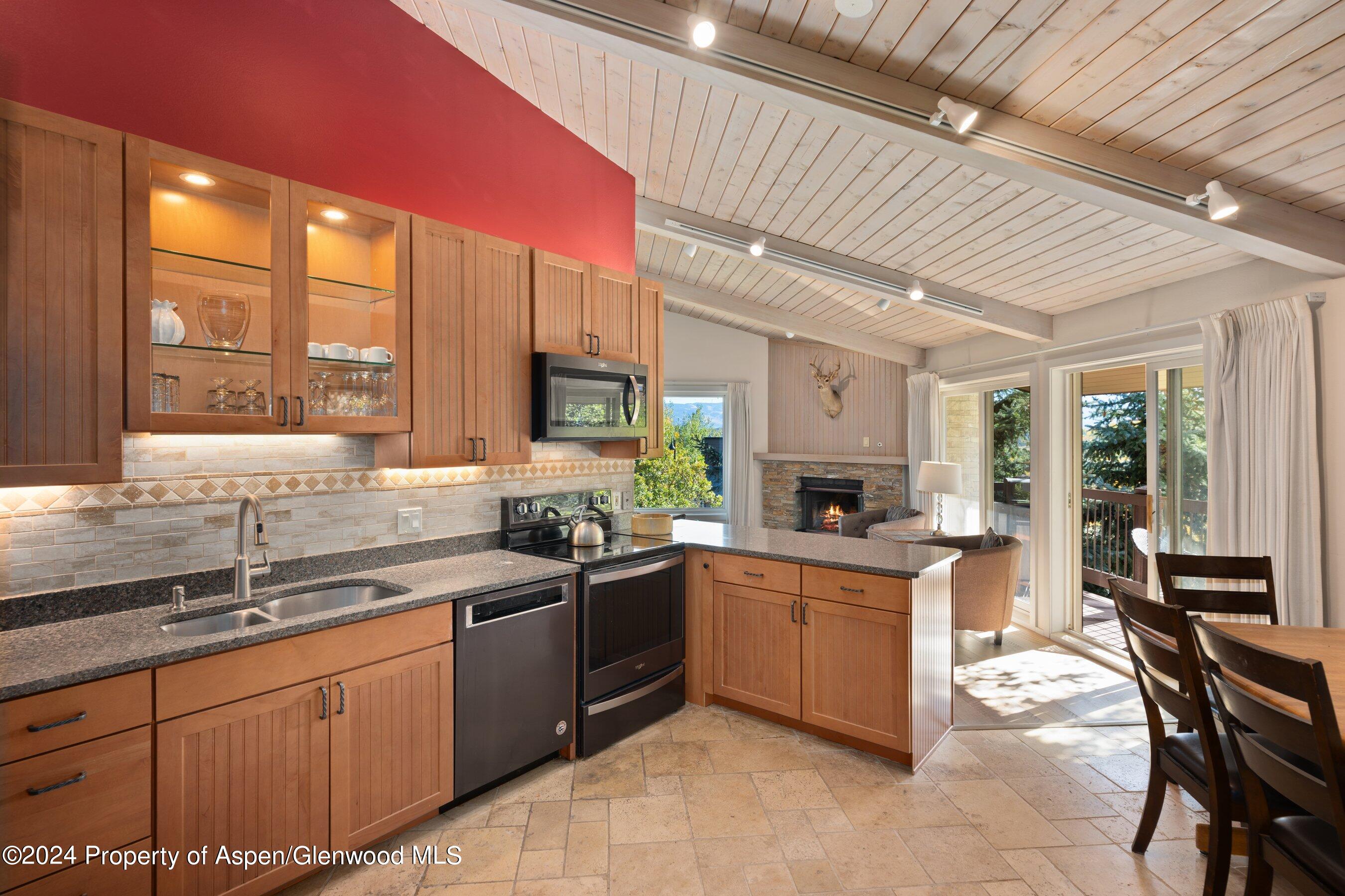 35 Upper Woodbridge Road, Unit 26EF Snowmass Village, CO 81615 - Photo 6 of 17 a kitchen with stainless steel appliances a sink stove and cabinets