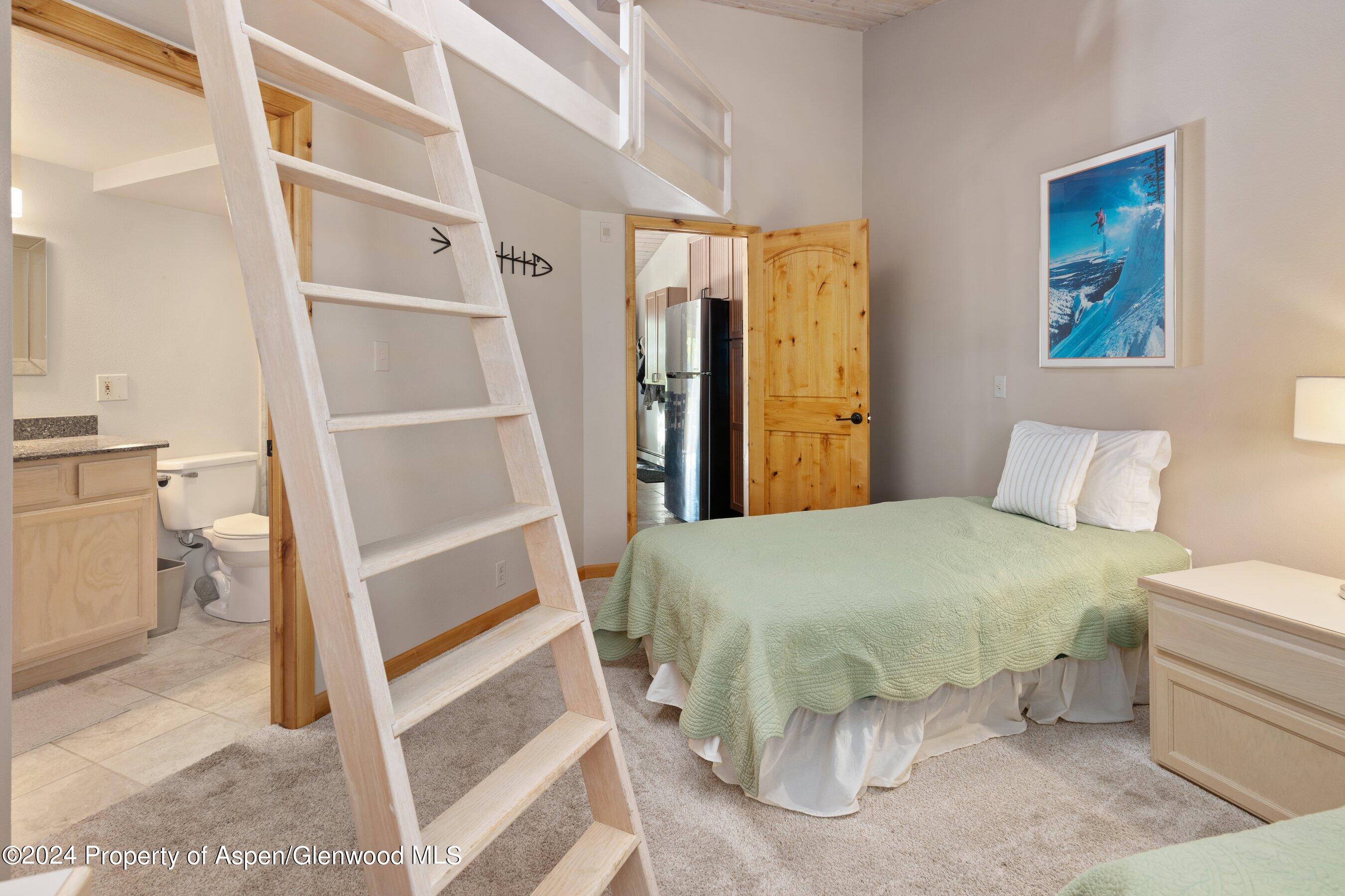 35 Upper Woodbridge Road, Unit 26EF Snowmass Village, CO 81615 - Photo 10 of 17 a bedroom with a bed and a window