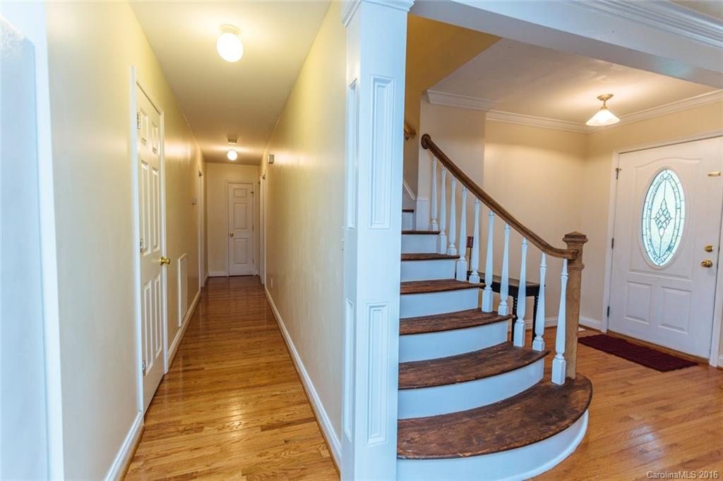 3114 Bush Road, Unit 19 Clover, SC 29710 - Photo 4 of 16 a view of a hallway with wooden floor and staircase