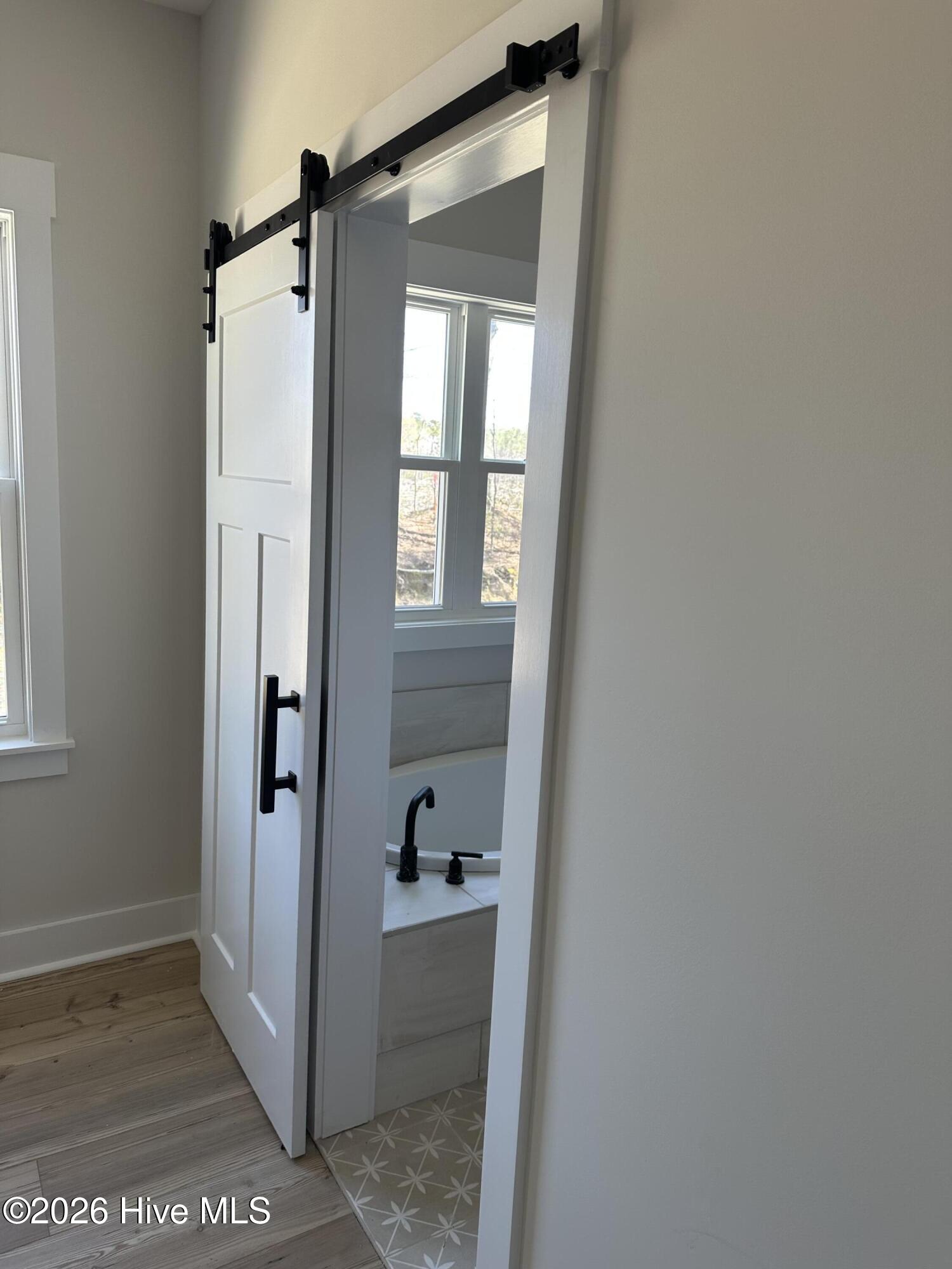 623 Winding Creek Road Rocky Point, NC 28457 - Photo 28 of 38 Barn door in master bedroom entry master bath