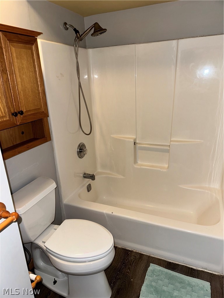 7495 Johnnycake Ridge Road Mentor, OH 44060 - Photo 27 of 50 Bathroom with toilet, hardwood / wood-style flooring, and bathing tub / shower combination