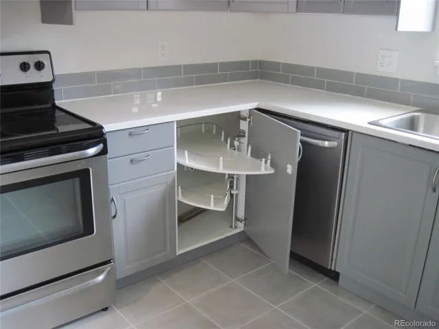a kitchen with a stove and a refrigerator