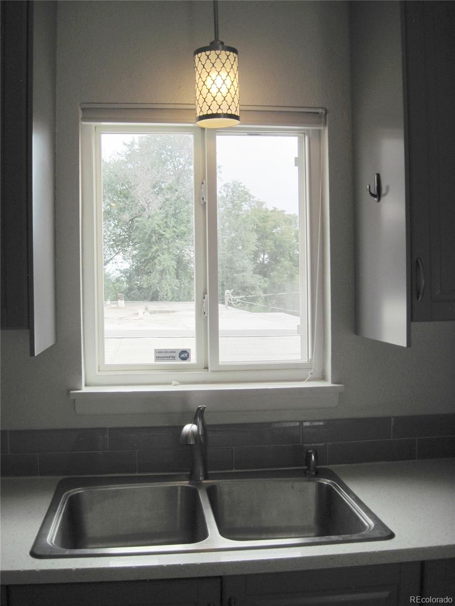 1014 Alexander Road Colorado Springs, CO 80909 - Photo 12 of 44 a kitchen that has a sink and a window