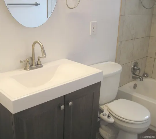 a bathroom with a sink toilet and a mirror