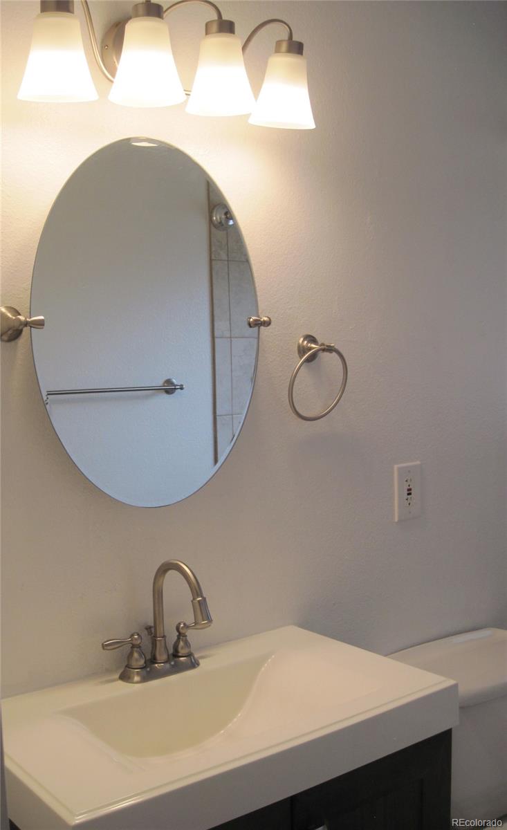 1014 Alexander Road Colorado Springs, CO 80909 - Photo 18 of 44 a bathroom with a sink and mirror