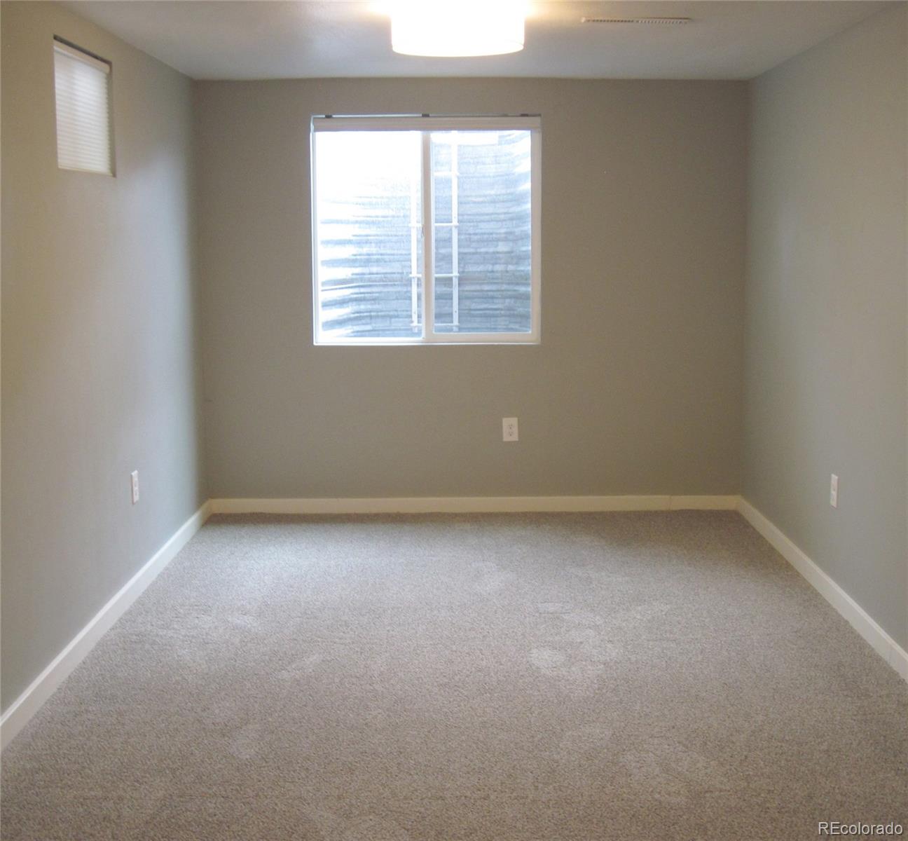 1014 Alexander Road Colorado Springs, CO 80909 - Photo 30 of 44 an empty room with a window