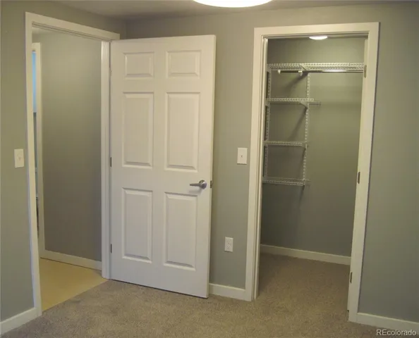 an empty room with closet area