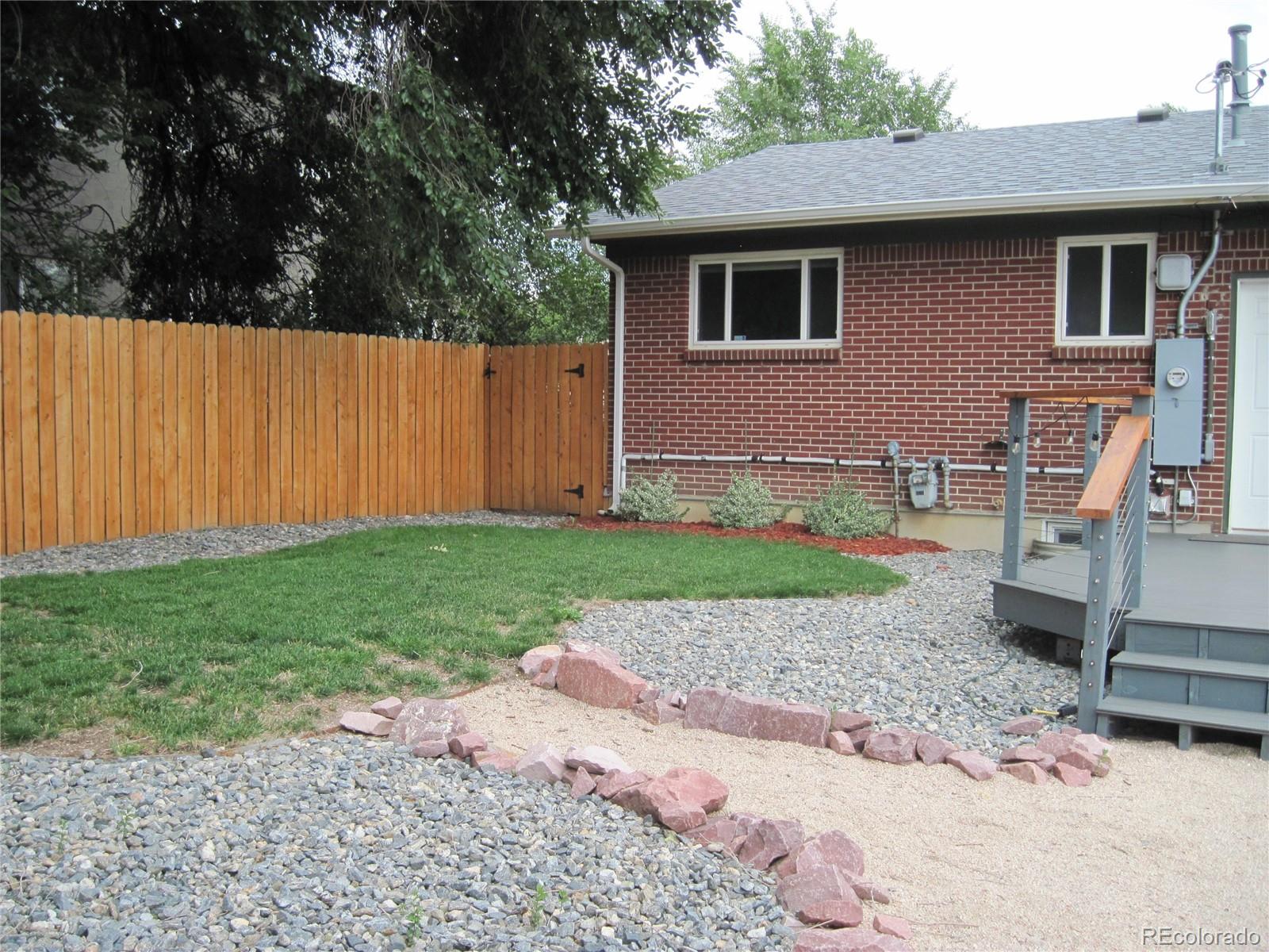 1014 Alexander Road Colorado Springs, CO 80909 - Photo 35 of 44 a front view of a house with garden