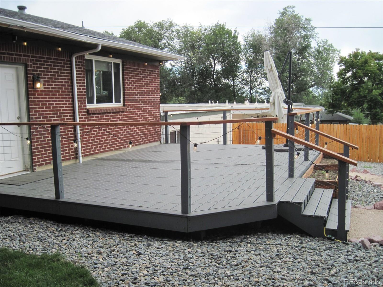 1014 Alexander Road Colorado Springs, CO 80909 - Photo 36 of 44 a view of a balcony with wooden floor and fence
