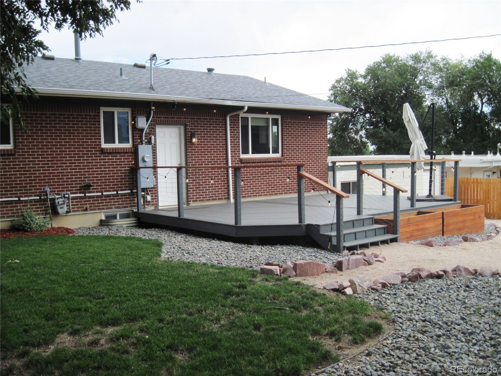 1014 Alexander Road Colorado Springs, CO 80909 - Photo 37 of 44 a view of a backyard with plants and a bench