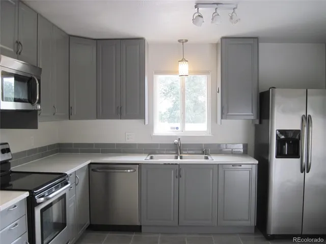 a kitchen with a sink stove and refrigerator