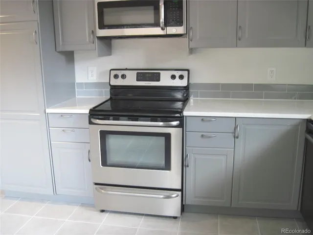 a stove top oven sitting inside of a kitchen