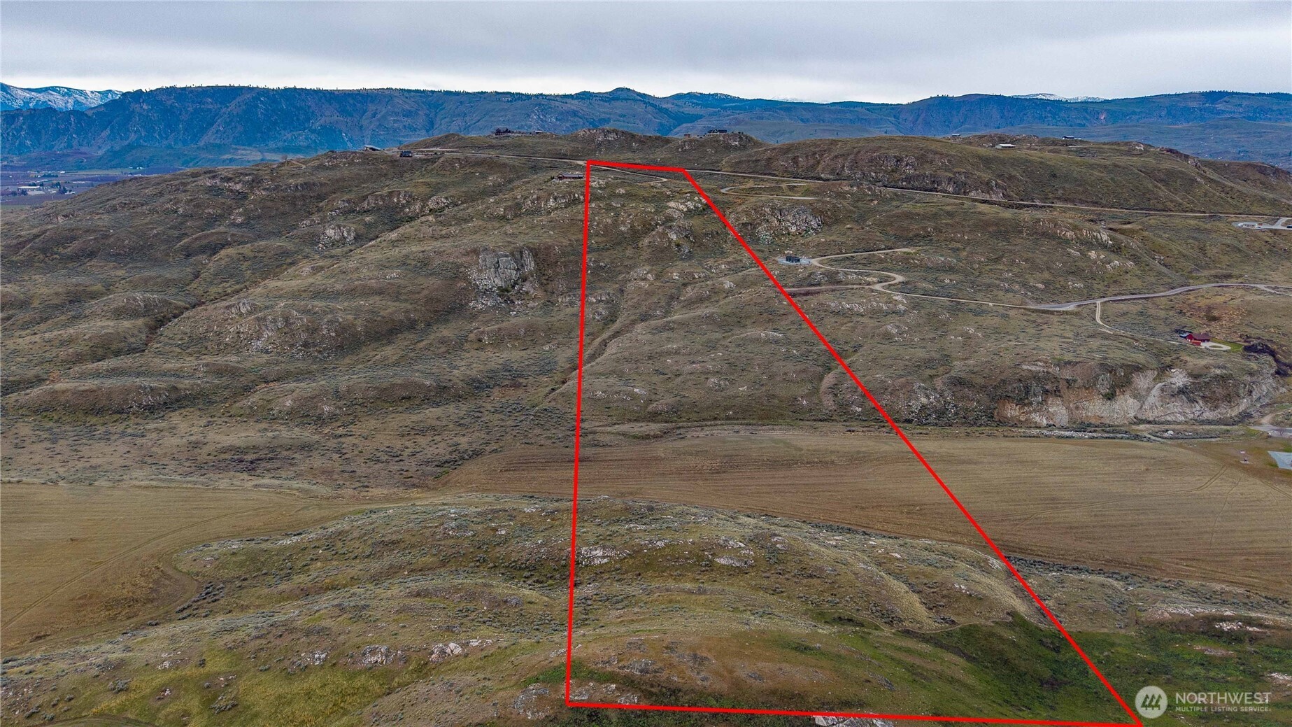 215 Plata Road Brewster, WA 98812 - Photo 11 of 40 a view of a dry yard with mountain
