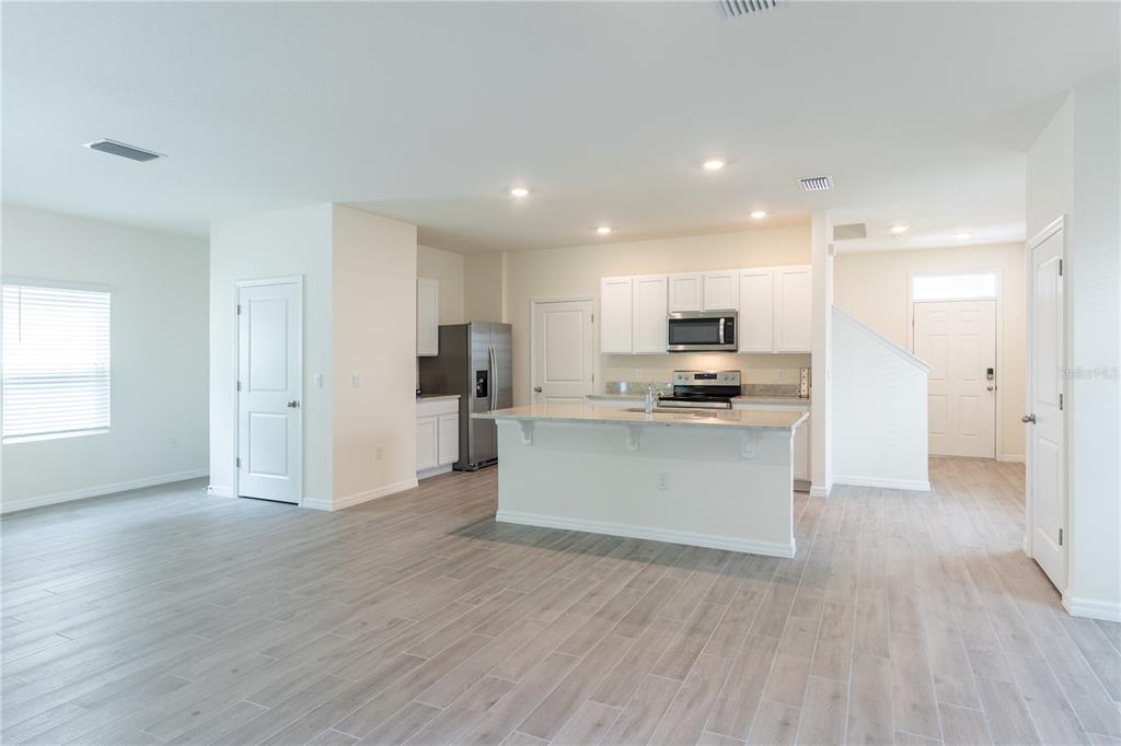 4807 Southwest 51st Terrace Gainesville, FL 32608 - Photo 11 of 35 a view of kitchen with granite countertop stainless steel appliances refrigerator sink and cabinets