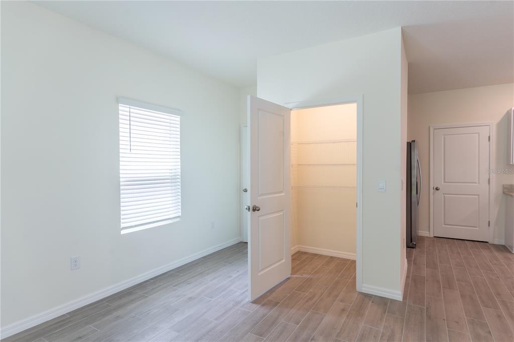 4807 Southwest 51st Terrace Gainesville, FL 32608 - Photo 12 of 35 an empty room with wooden floor and windows