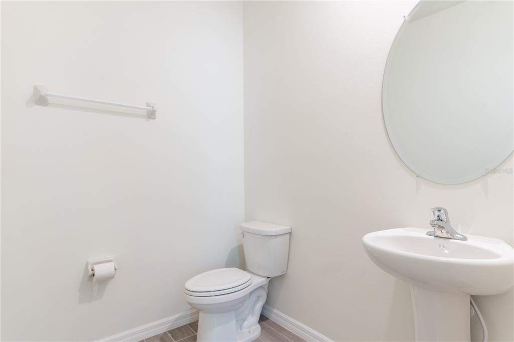 4807 Southwest 51st Terrace Gainesville, FL 32608 - Photo 13 of 35 a bathroom with a sink toilet and a mirror