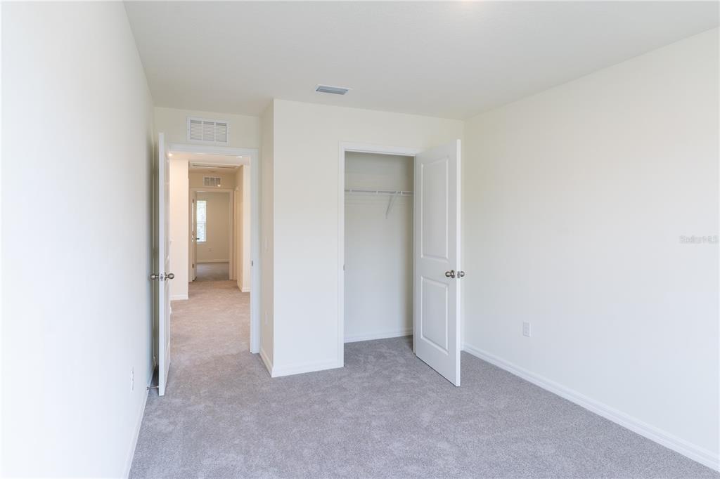 4807 Southwest 51st Terrace Gainesville, FL 32608 - Photo 19 of 35 a view of a room with a hallway and closet