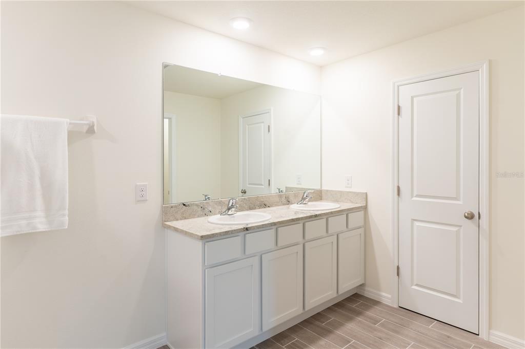 4807 Southwest 51st Terrace Gainesville, FL 32608 - Photo 25 of 35 a bathroom with a sink and a mirror
