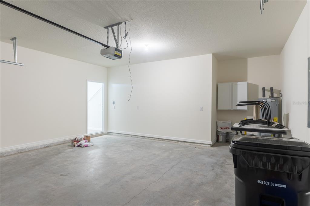 4807 Southwest 51st Terrace Gainesville, FL 32608 - Photo 34 of 35 a view of a kitchen with a stove wooden floor and a ceiling fan