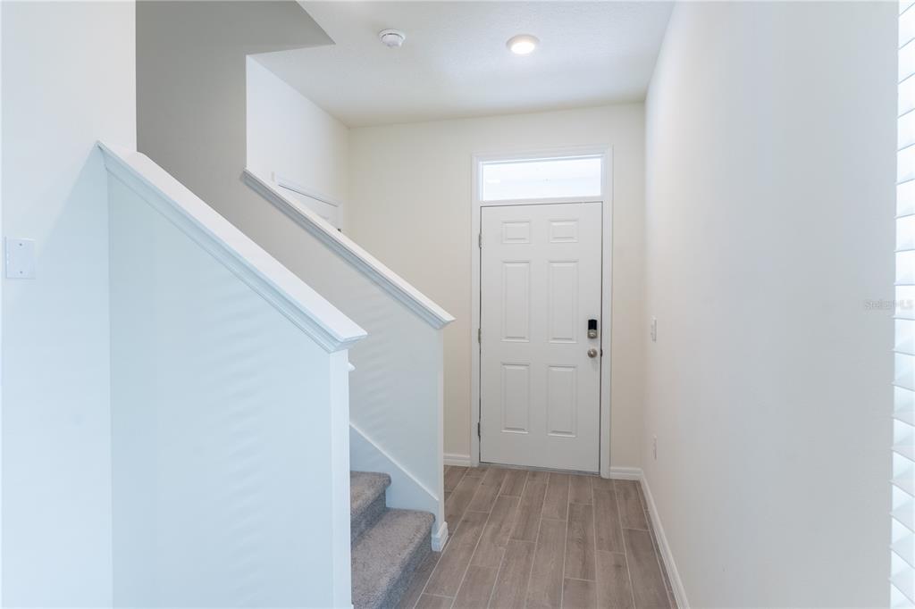4807 Southwest 51st Terrace Gainesville, FL 32608 - Photo 4 of 35 a view of hallway with stairs and wooden floor