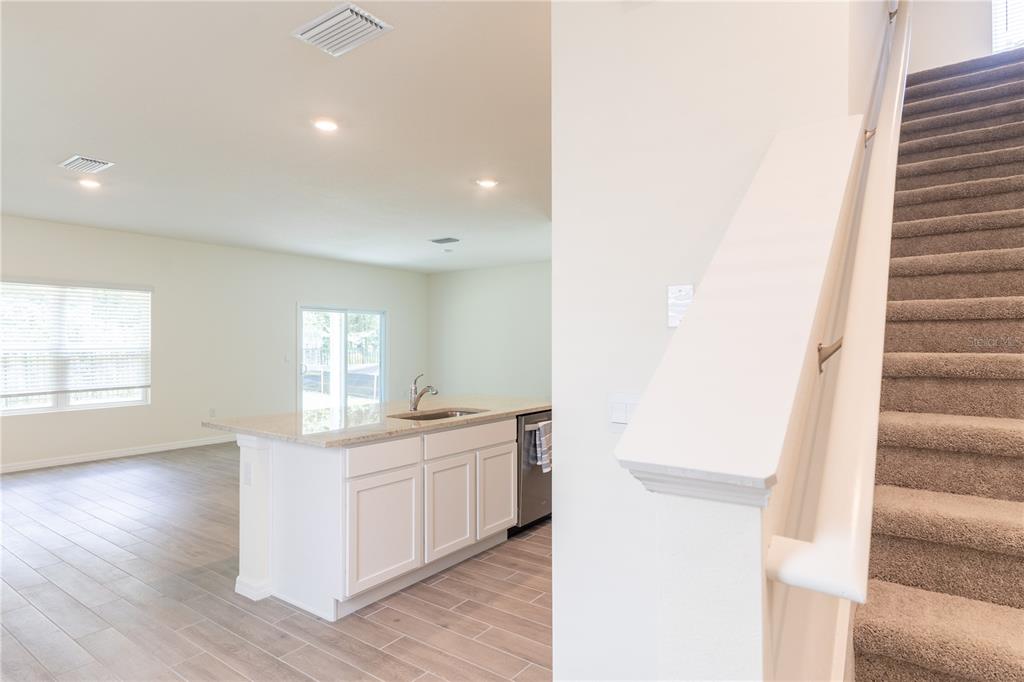 4807 Southwest 51st Terrace Gainesville, FL 32608 - Photo 6 of 35 a view of a kitchen with a sink and dishwasher with wooden floor