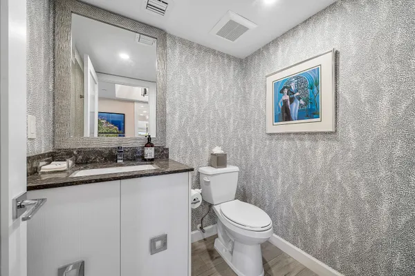 a bathroom with a sink toilet and mirror