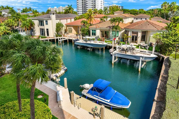 a view of a patio with lawn chairs under an umbrella