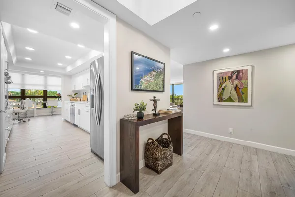 a view of a kitchen with furniture and a refrigerator