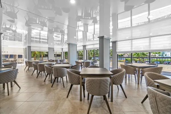 a living room with lots of chairs and glass door
