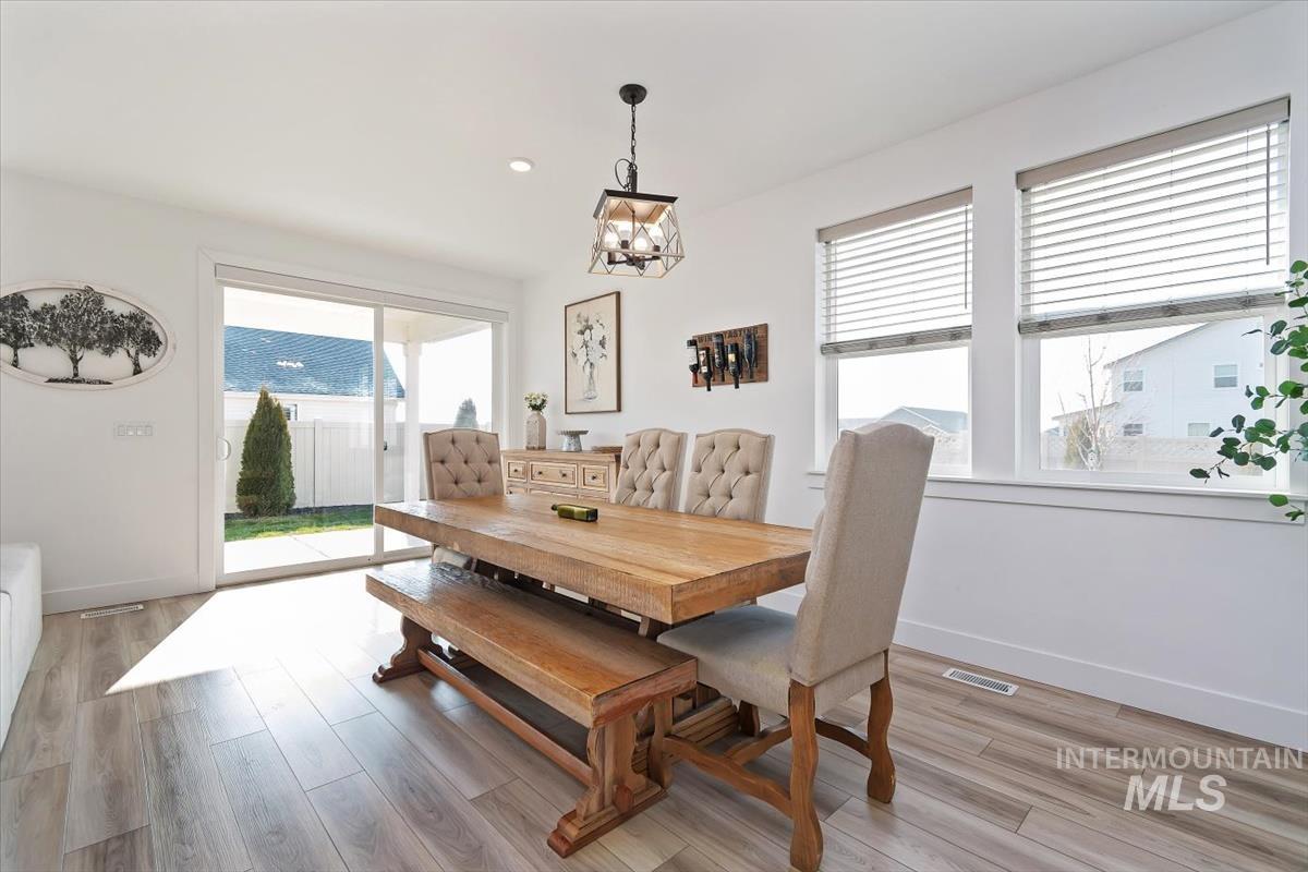 14361 Fractus Drive Caldwell, ID 83607 - Photo 13 of 50 Dining room with light wood finished floors, a chandelier, healthy amount of natural light, and recessed lighting