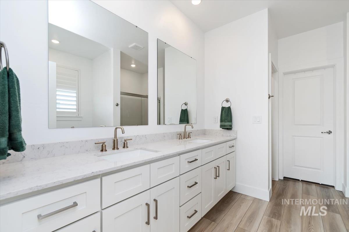 14361 Fractus Drive Caldwell, ID 83607 - Photo 16 of 50 Bathroom featuring a stall shower, double vanity, light wood finished floors, and recessed lighting