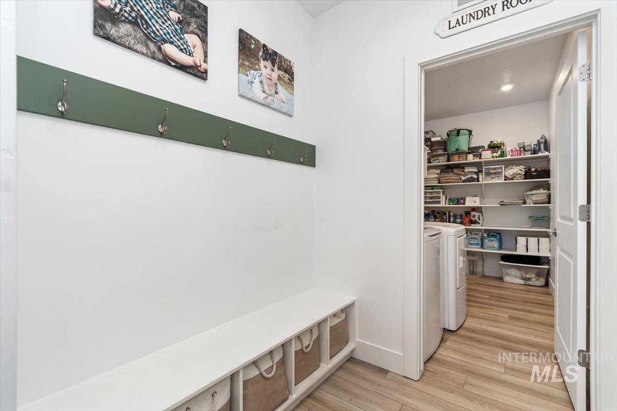 14361 Fractus Drive Caldwell, ID 83607 - Photo 19 of 50 Mudroom featuring light wood-style floors and washing machine and clothes dryer
