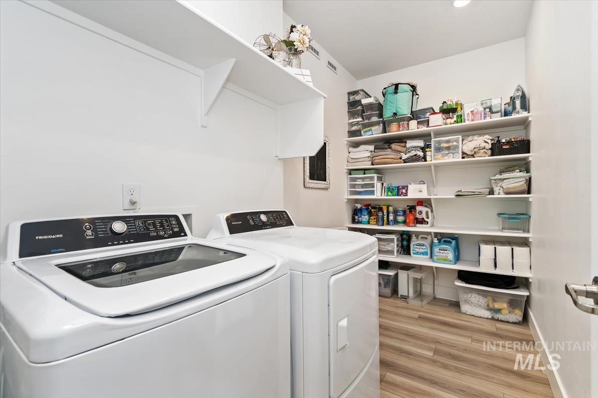 14361 Fractus Drive Caldwell, ID 83607 - Photo 20 of 50 Laundry area with light wood-type flooring and separate washer and dryer