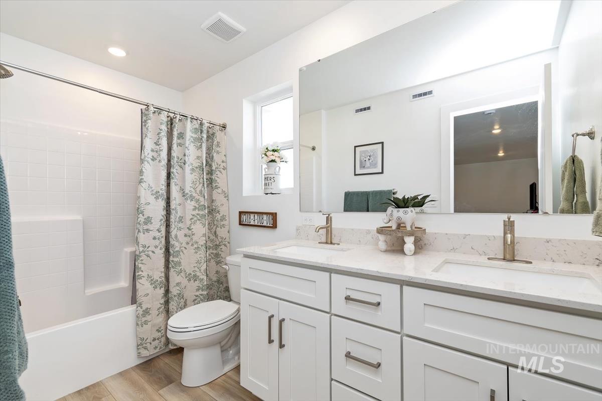 14361 Fractus Drive Caldwell, ID 83607 - Photo 23 of 50 Bathroom featuring shower / tub combo, double vanity, and light wood finished floors