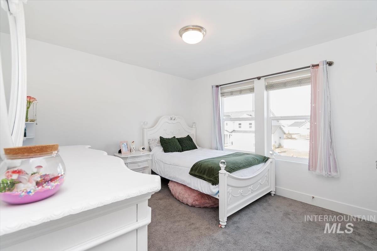 14361 Fractus Drive Caldwell, ID 83607 - Photo 24 of 50 Bedroom with dark carpet and baseboards