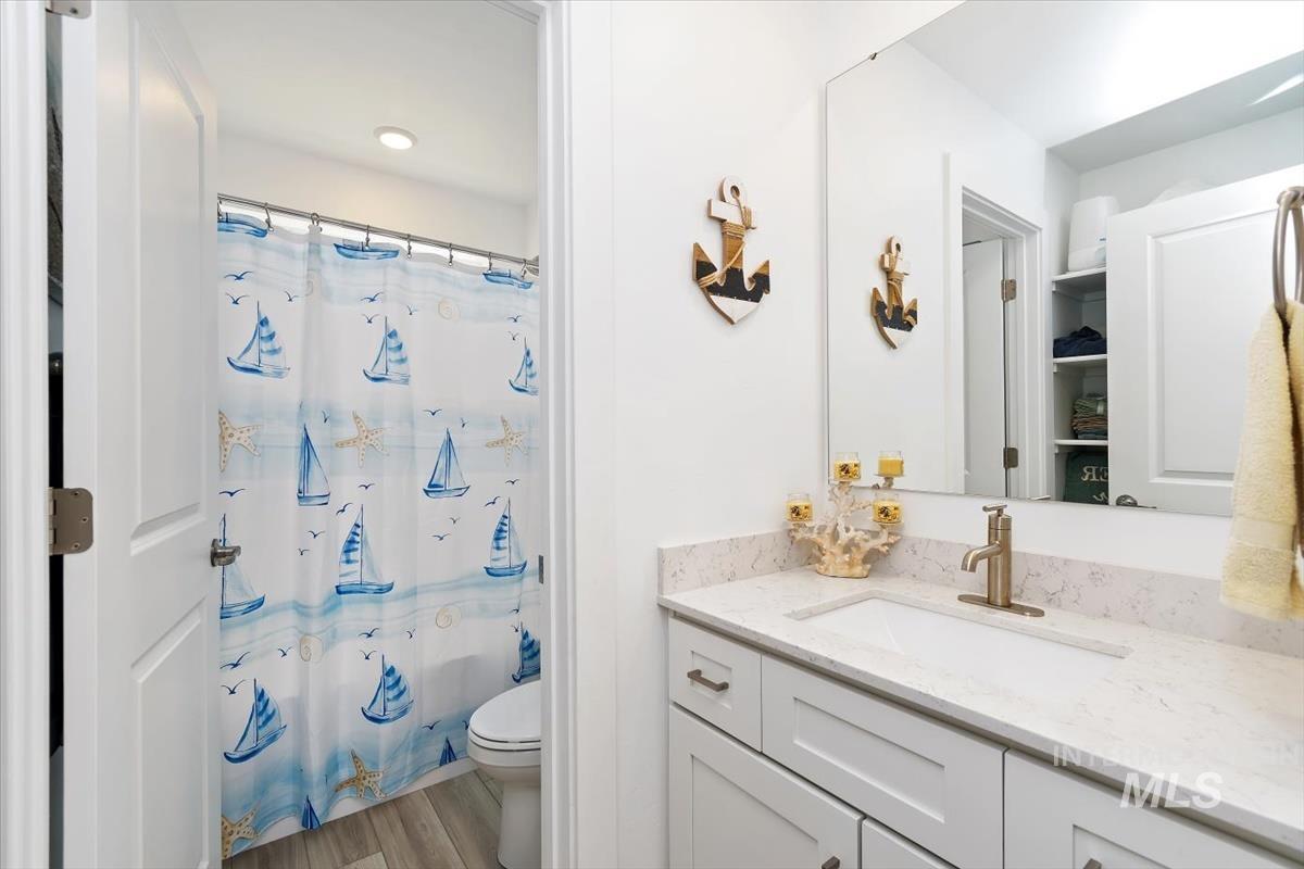 14361 Fractus Drive Caldwell, ID 83607 - Photo 25 of 50 Bathroom featuring curtained shower, vanity, and light wood-style flooring